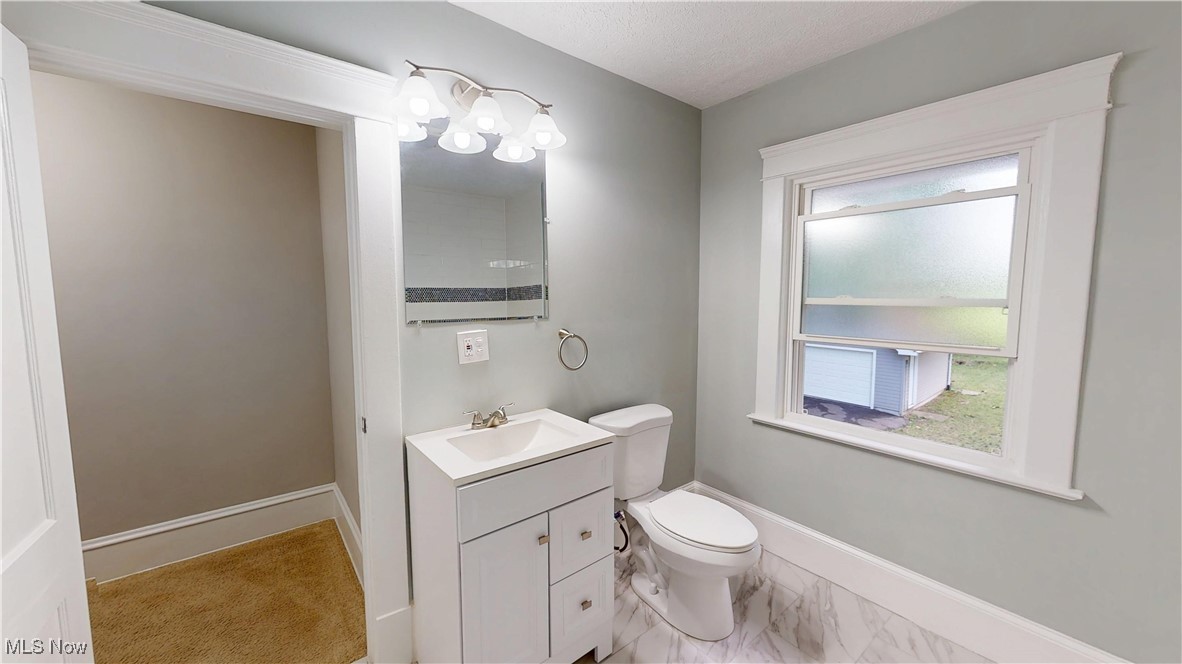 3174 Oak Road Cleveland, OH 44118 - Photo 15 of 33 Bathroom featuring vanity, a chandelier, and marble look tile flooring
