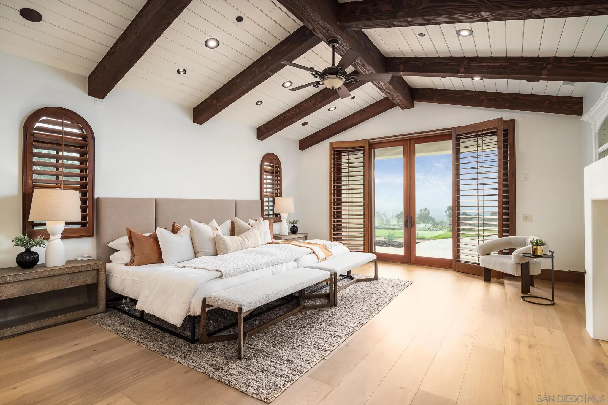 8415 Run Of The Knolls Court San Diego, CA 92127 - Photo 22 of 39 a spacious bedroom with a bed couch and a large window