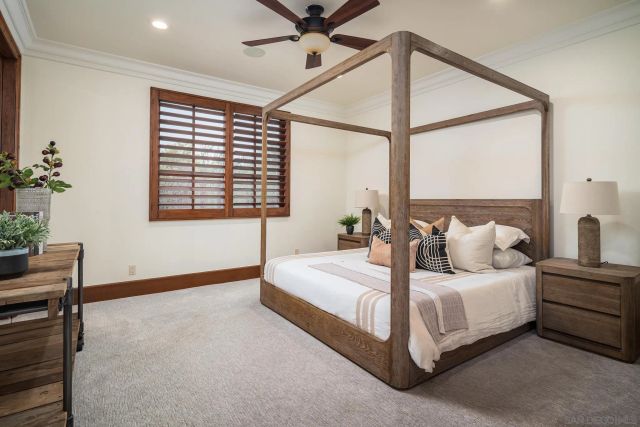 a bedroom with double bed and a window