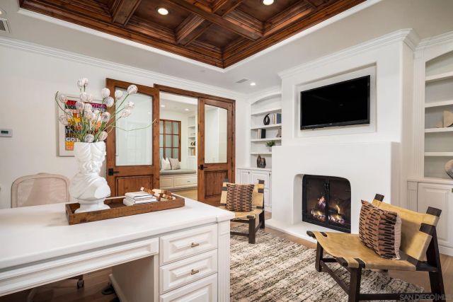 a living room with furniture fireplace and flat screen tv