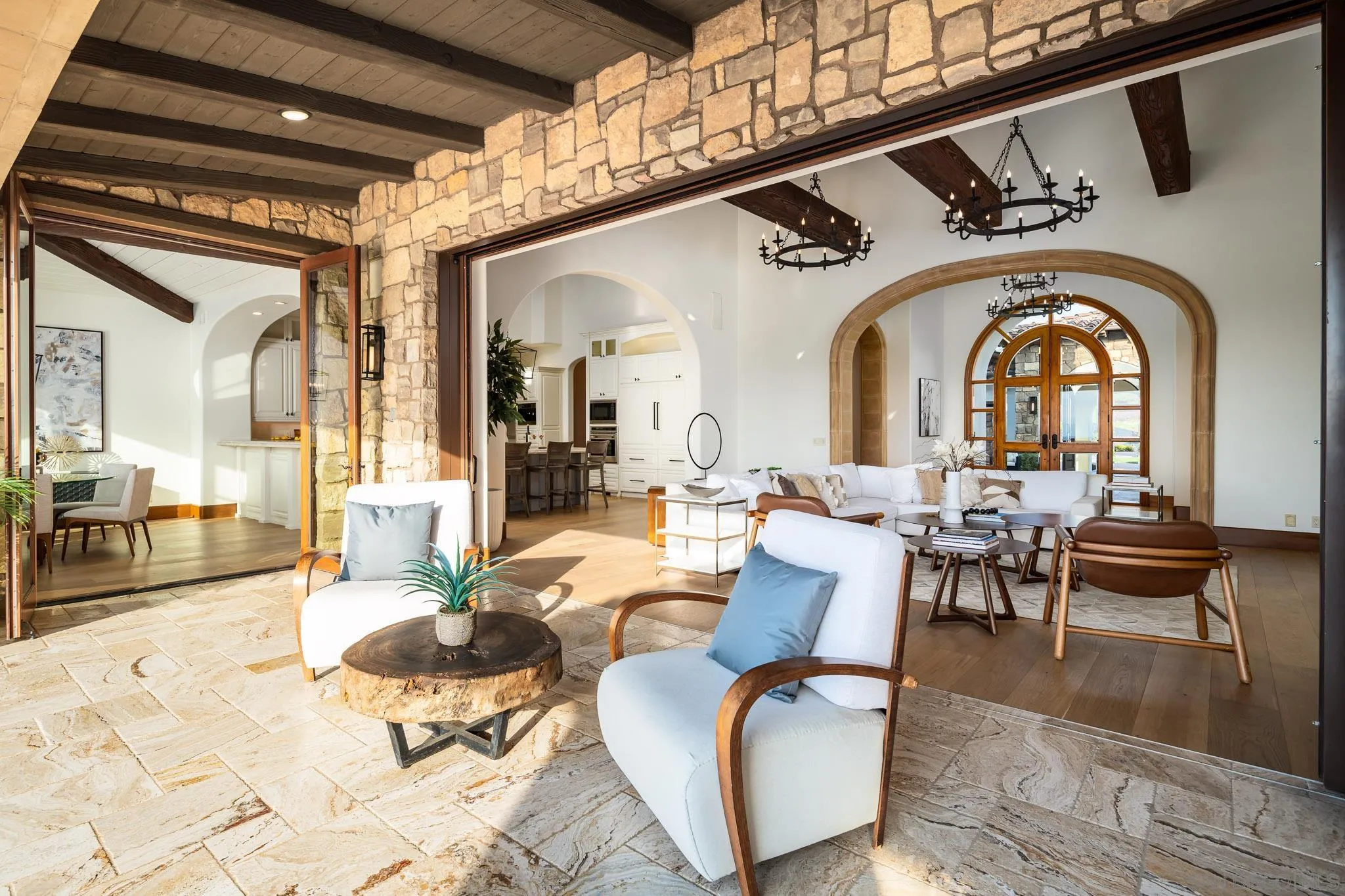 8415 Run Of The Knolls Court San Diego, CA 92127 - Photo 31 of 39 a living room with couches a dining table and chairs with wooden floor