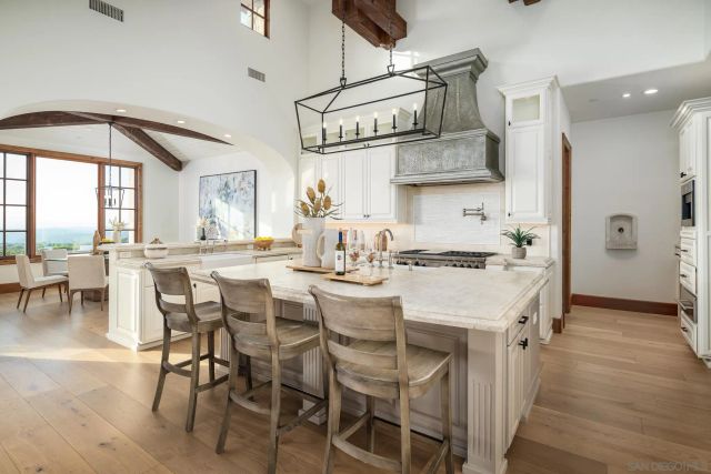a large kitchen with a table and chairs