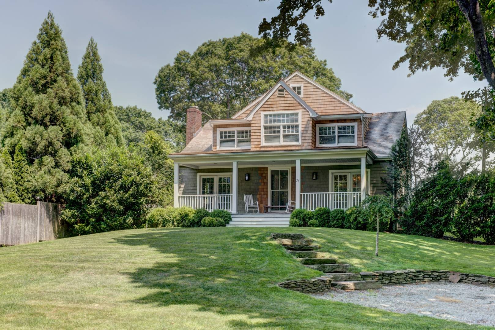 26 Wireless Road East Hampton, NY 11937 - Photo 1 of 13 a front view of a house with a yard