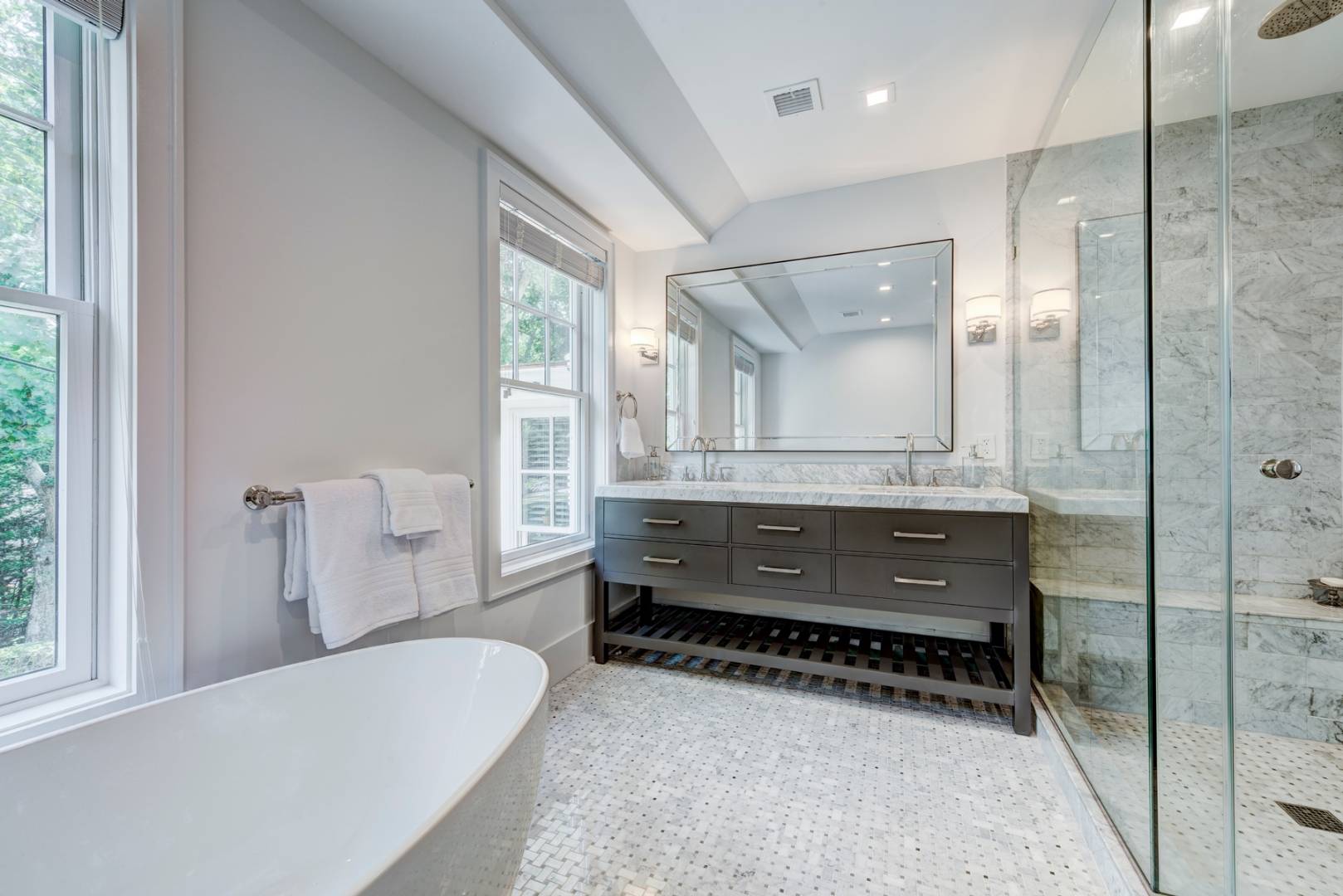 26 Wireless Road East Hampton, NY 11937 - Photo 7 of 13 a bathroom with a tub a double vanity sink and a large mirror