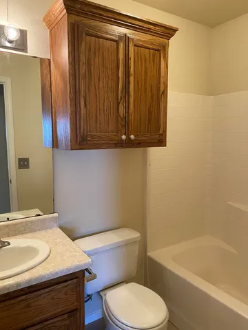 a bathroom with a sink a toilet and bathtub