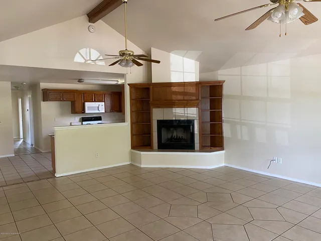 a view of a kitchen with a sink and a fireplace