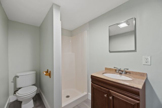 a bathroom with a sink a toilet and a mirror