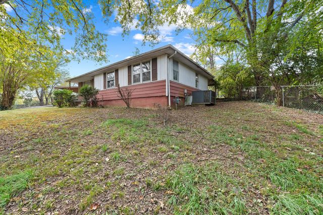 a house with trees in the background