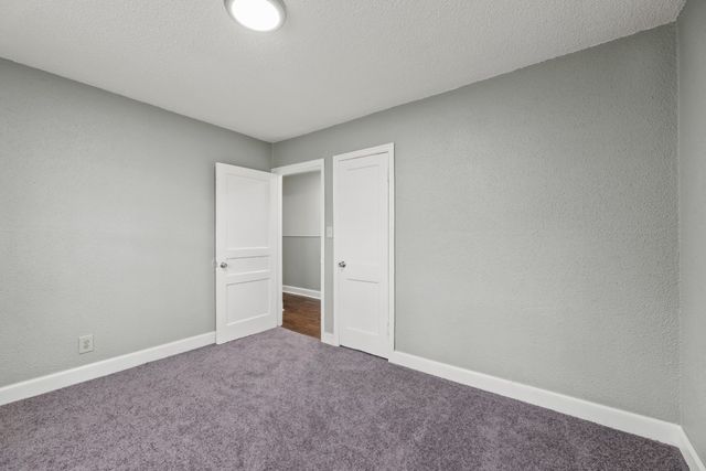 a view of an empty room and closet area