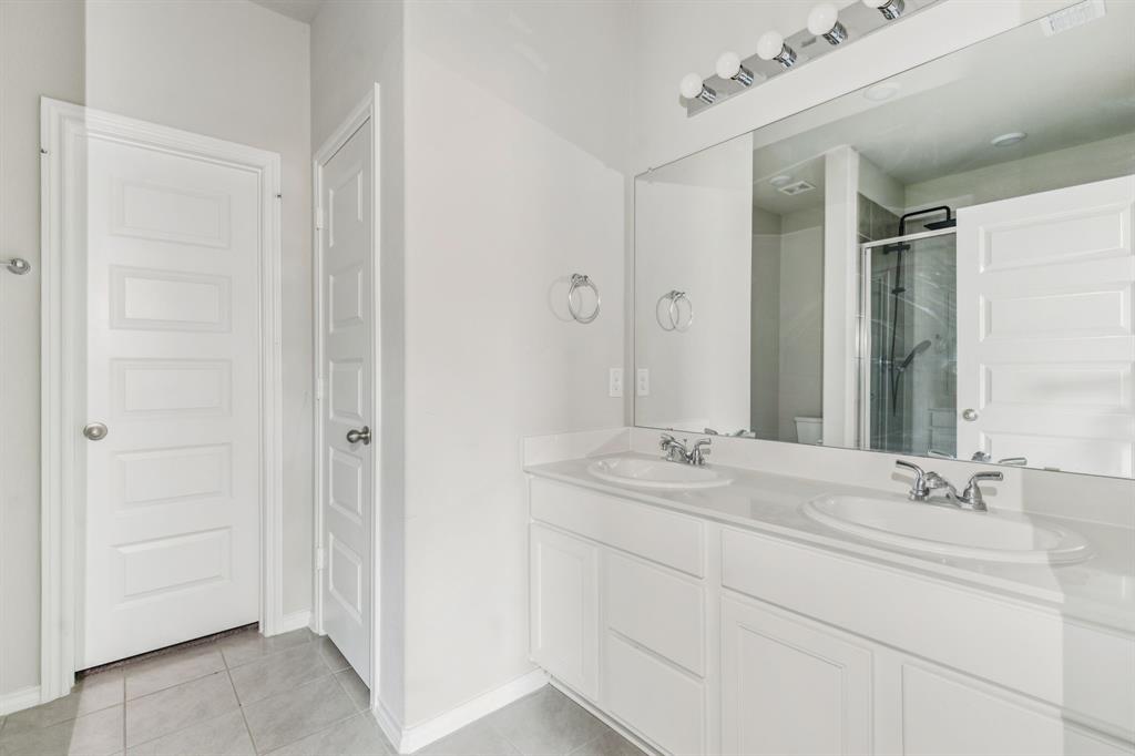 969 Ravenwood Lane Van Alstyne, TX 75495 - Photo 15 of 27 a bathroom with a double vanity sink and a mirror