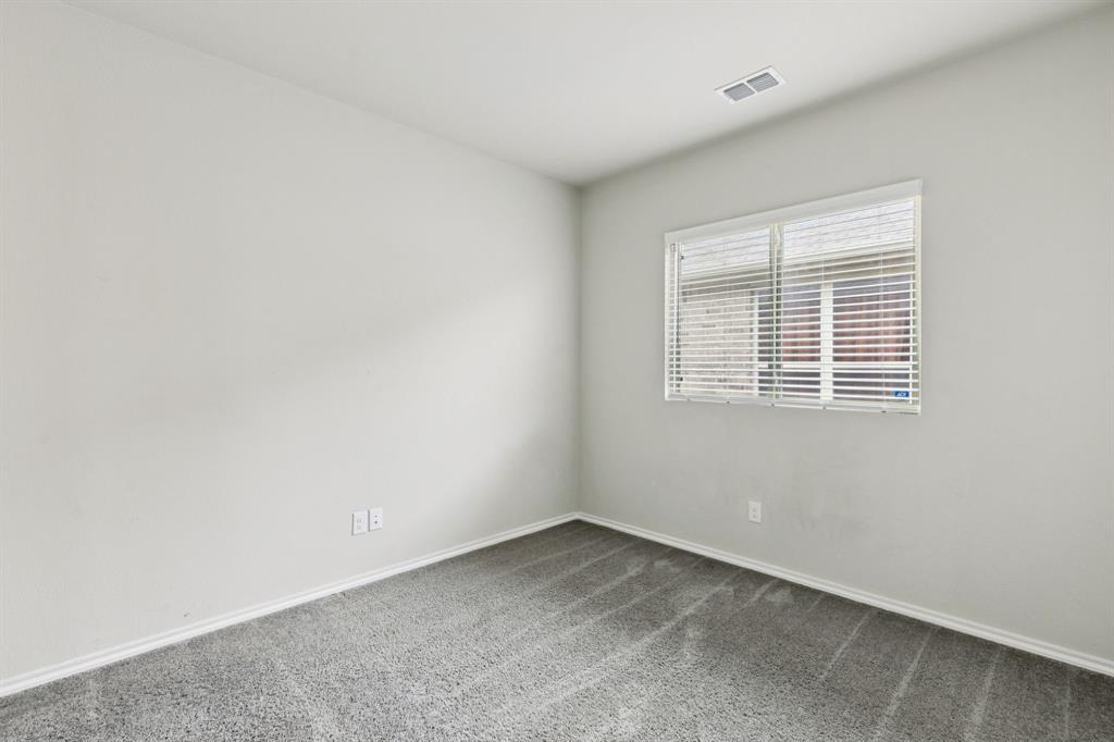 969 Ravenwood Lane Van Alstyne, TX 75495 - Photo 16 of 27 an empty room with a window