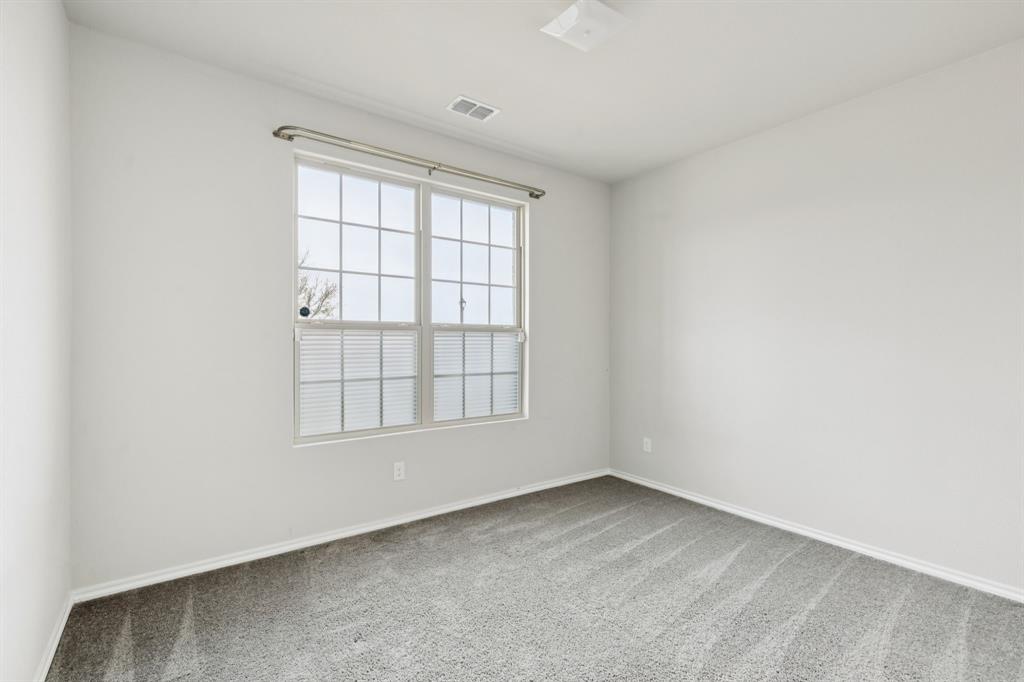 969 Ravenwood Lane Van Alstyne, TX 75495 - Photo 17 of 27 an empty room with a window