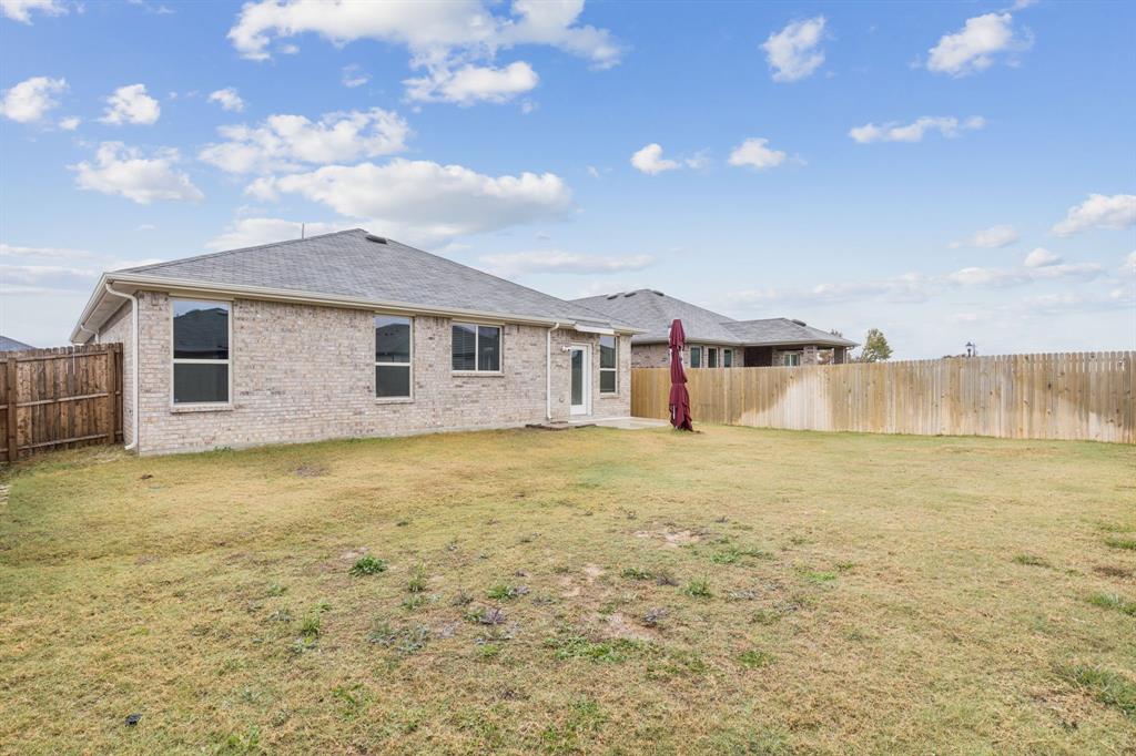 969 Ravenwood Lane Van Alstyne, TX 75495 - Photo 23 of 27 a view of a house with a backyard