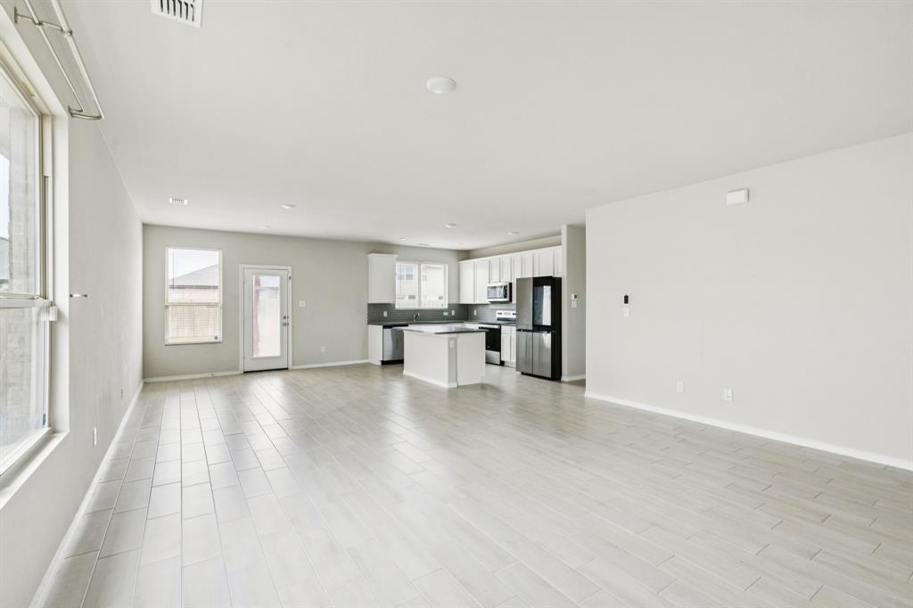 969 Ravenwood Lane Van Alstyne, TX 75495 - Photo 6 of 27 a view of empty room with wooden floor