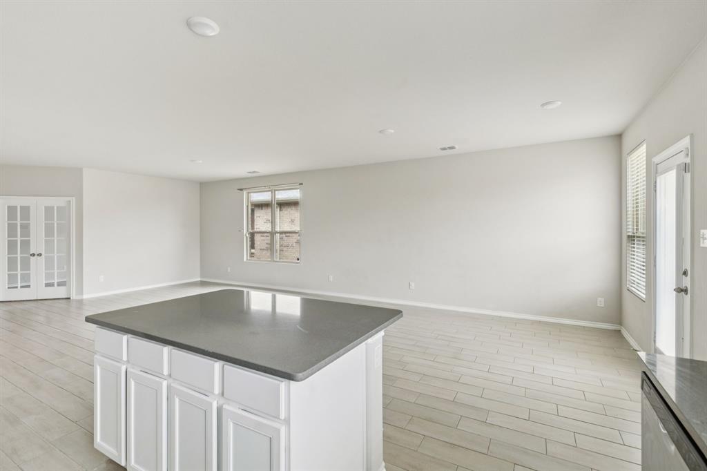 969 Ravenwood Lane Van Alstyne, TX 75495 - Photo 27 of 27 a view of kitchen island hardwood floor and hallway
