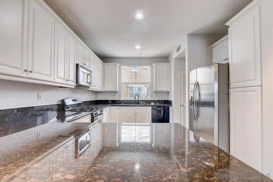 10225 Daybreak Lane, Unit 2 Santee, CA 92071 - Photo 4 of 20 a kitchen with granite countertop a refrigerator and a sink