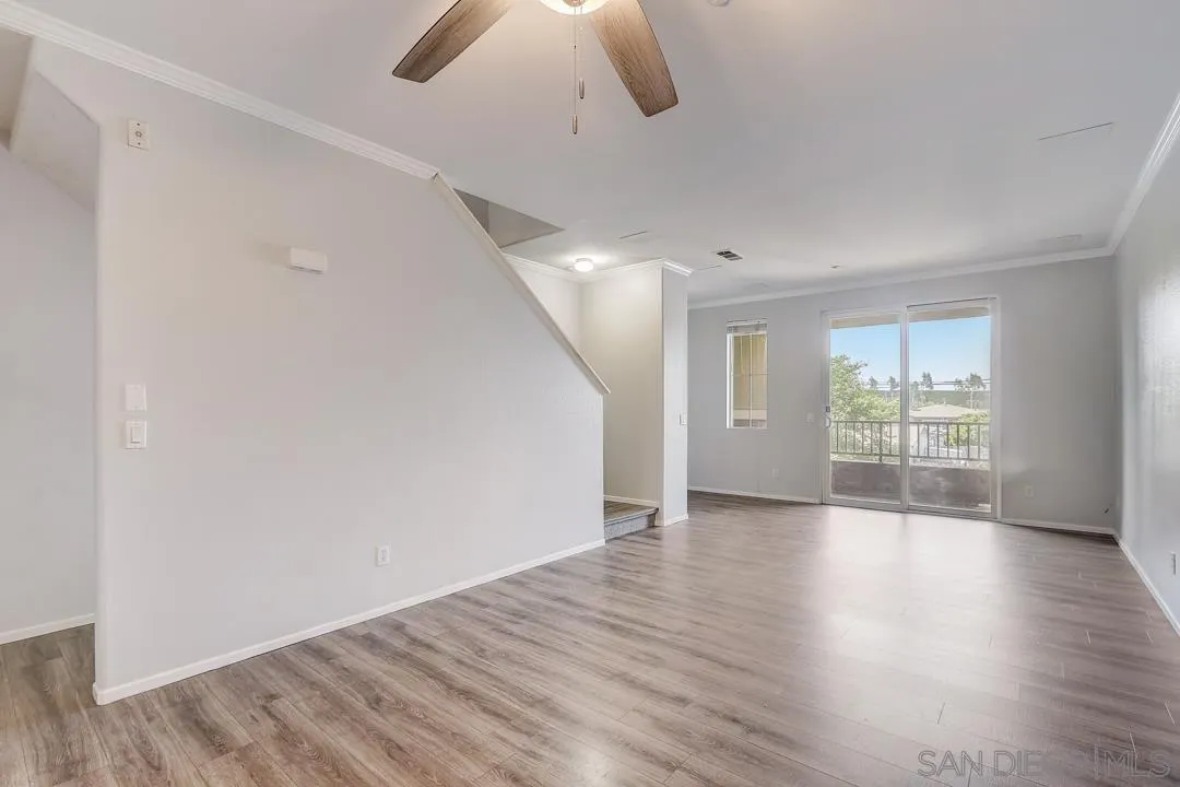 10225 Daybreak Lane, Unit 2 Santee, CA 92071 - Photo 5 of 20 a view of an empty room with wooden floor and a window
