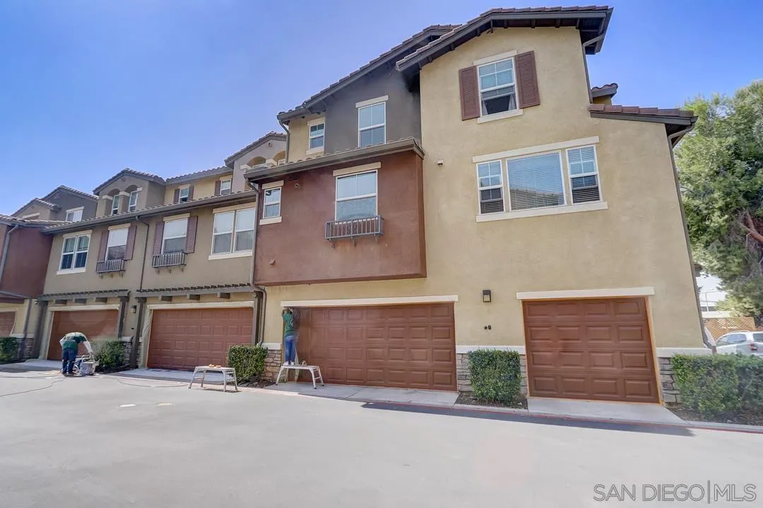 10225 Daybreak Lane, Unit 2 Santee, CA 92071 - Photo 8 of 20 a front view of a house with a yard and garage