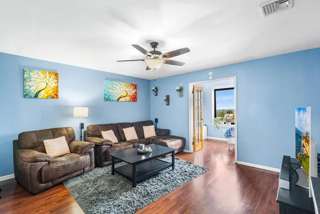 a living room with furniture and wooden floor