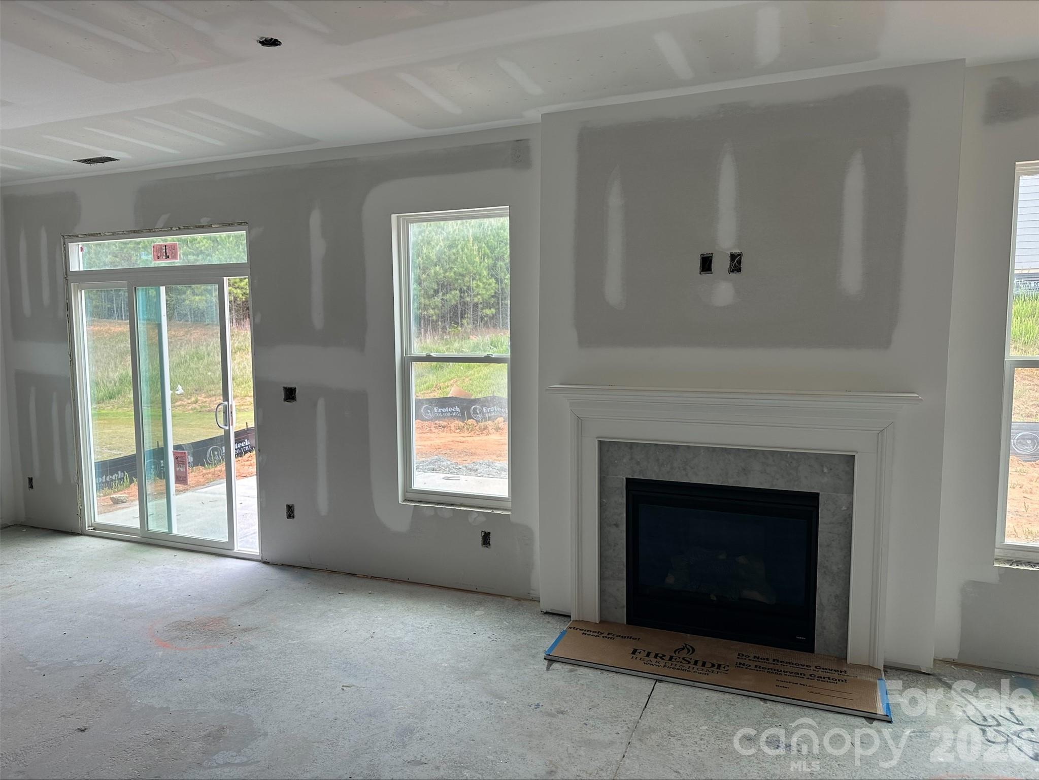 2229 Tabor Road Sherrills Ford, NC 28673 - Photo 7 of 8 an empty room with windows and fireplace