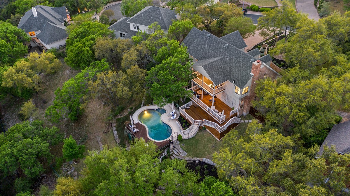 an aerial view of house with outdoor space and swimming pool