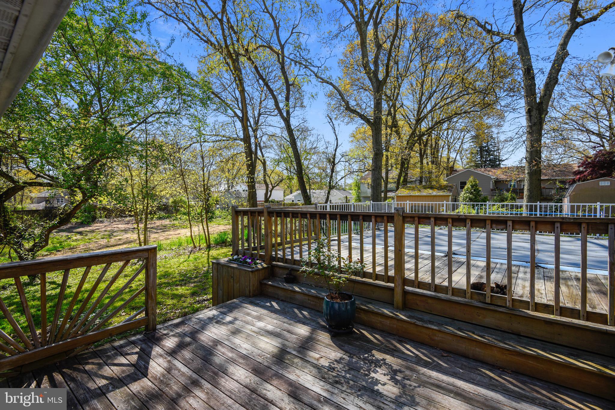 552 Sunset Knoll Road Pasadena, MD 21122 - Photo 13 of 36 a street view with wooden fence and trees