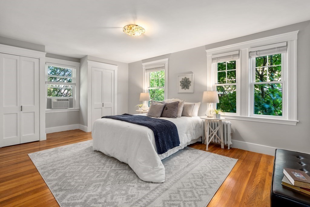 98 Hillside Avenue Arlington, MA 02476 - Photo 20 of 36 a bedroom with a bed and wooden floor