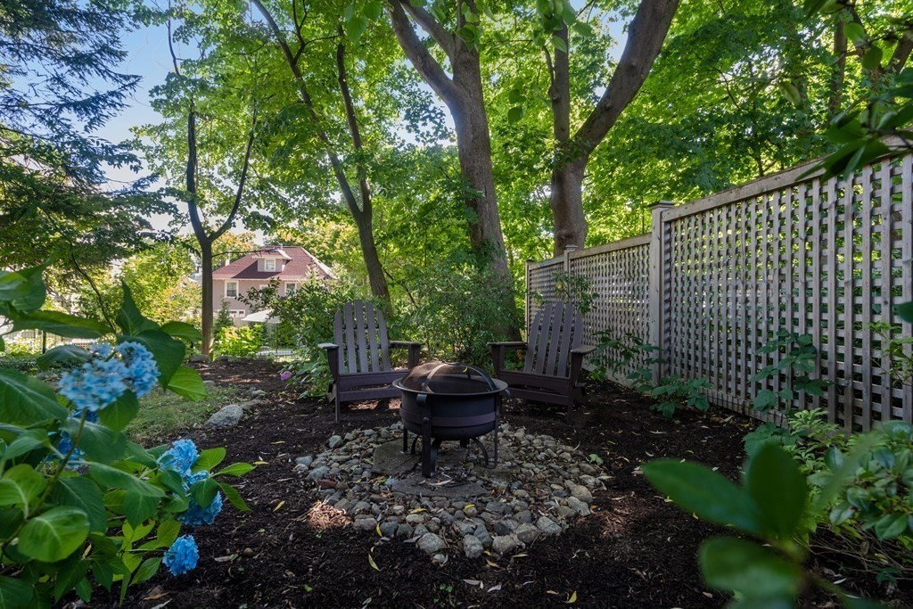 98 Hillside Avenue Arlington, MA 02476 - Photo 35 of 36 a view of a garden with a bench