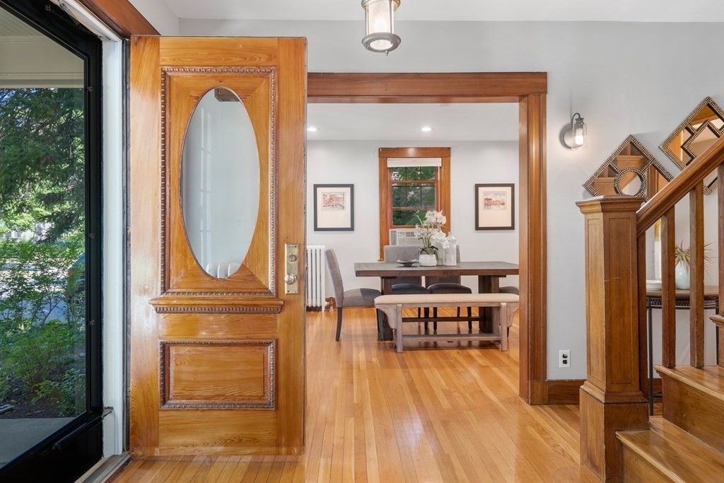 98 Hillside Avenue Arlington, MA 02476 - Photo 4 of 36 a view of a livingroom with furniture wooden floor mirror and windows