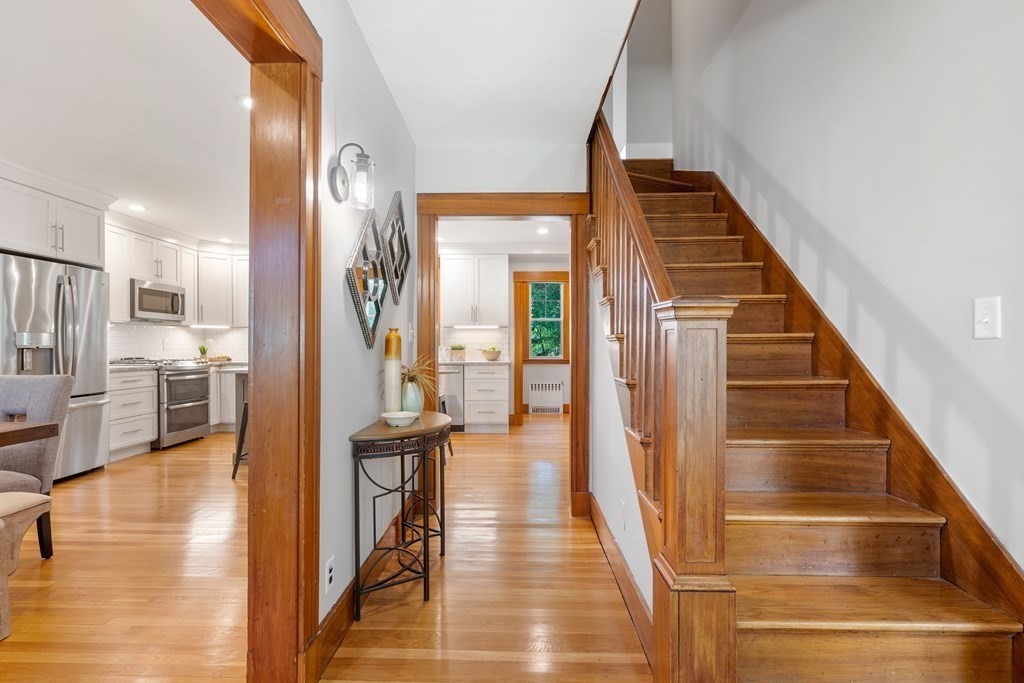 98 Hillside Avenue Arlington, MA 02476 - Photo 5 of 36 a view of a hallway with wooden floor and staircase