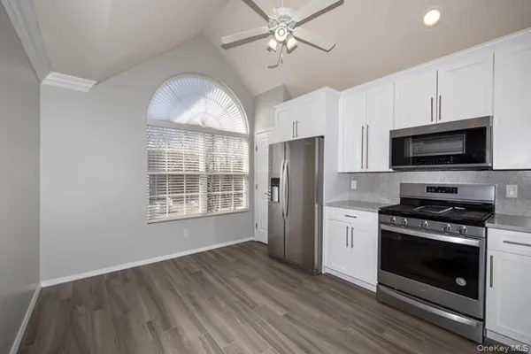 a kitchen with stainless steel appliances a stove microwave and a refrigerator