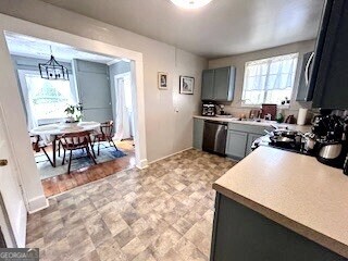 601 Heard Augusta, GA 30904 - Photo 13 of 51 a kitchen with stainless steel appliances granite countertop a stove top oven a sink a dining table and chairs with wooden floor