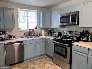 601 Heard Augusta, GA 30904 - Photo 14 of 51 a kitchen with stainless steel appliances granite countertop a stove a sink and a microwave