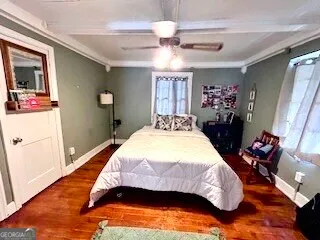 a bedroom with a bed dresser and mirror