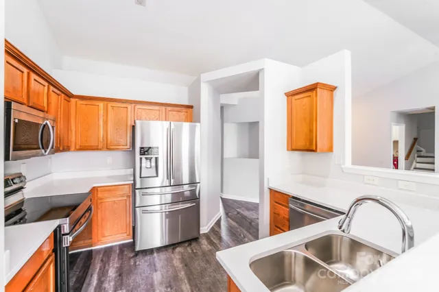 a kitchen with stainless steel appliances a refrigerator and a sink