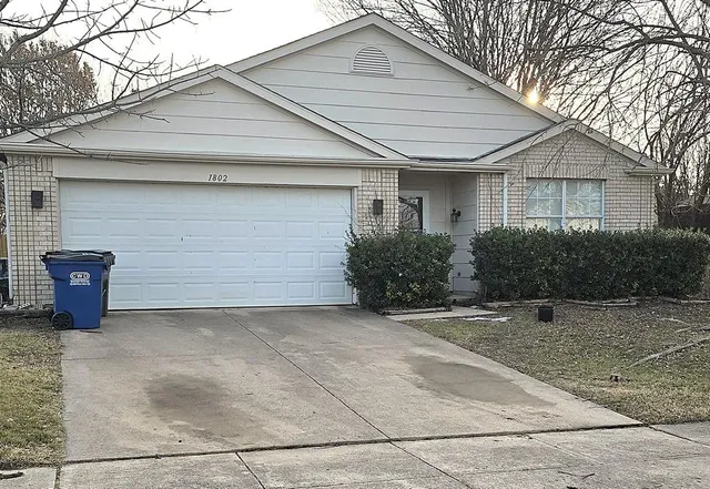 an empty room with wooden floor and a window