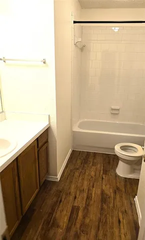 an empty room with wooden floor and entrance