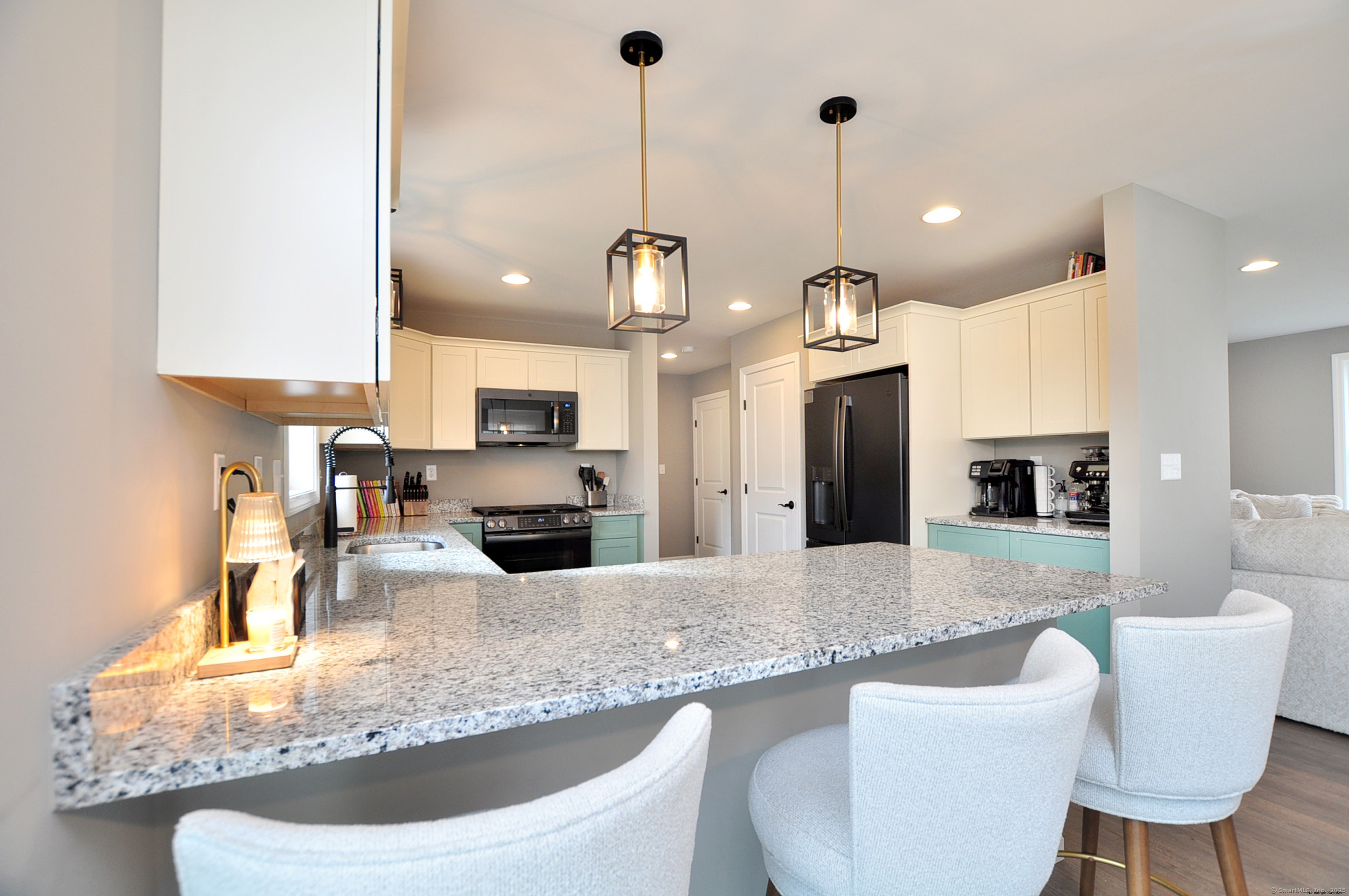 34 West River Road East Windsor, CT 06088 - Photo 12 of 31 a kitchen with stainless steel appliances granite countertop a sink a microwave a refrigerator and chairs