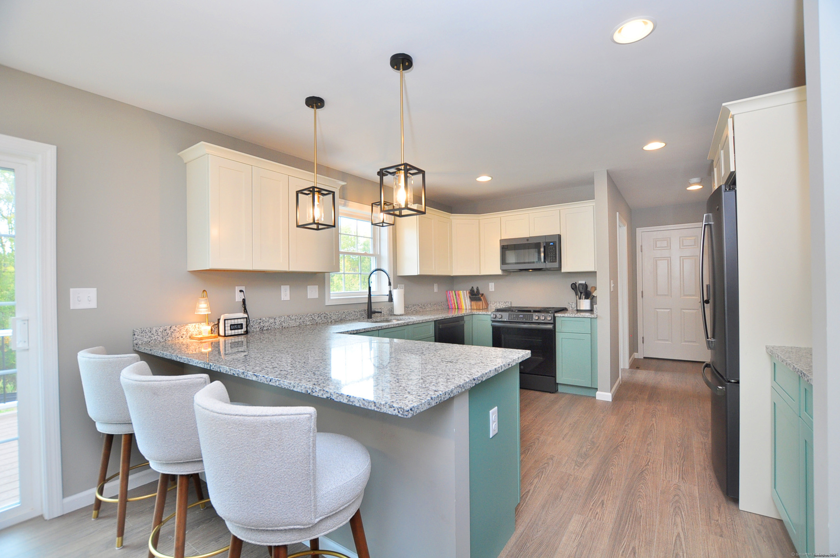 34 West River Road East Windsor, CT 06088 - Photo 14 of 31 a kitchen with refrigerator cabinets dining table and chairs