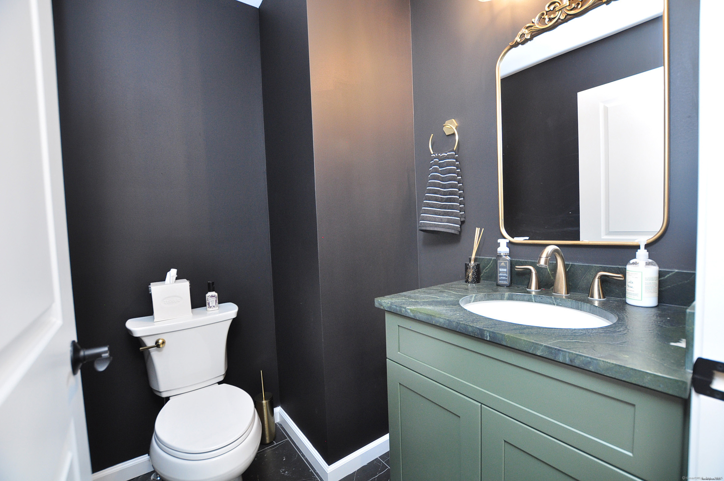 34 West River Road East Windsor, CT 06088 - Photo 20 of 31 a bathroom with a toilet a sink and mirror