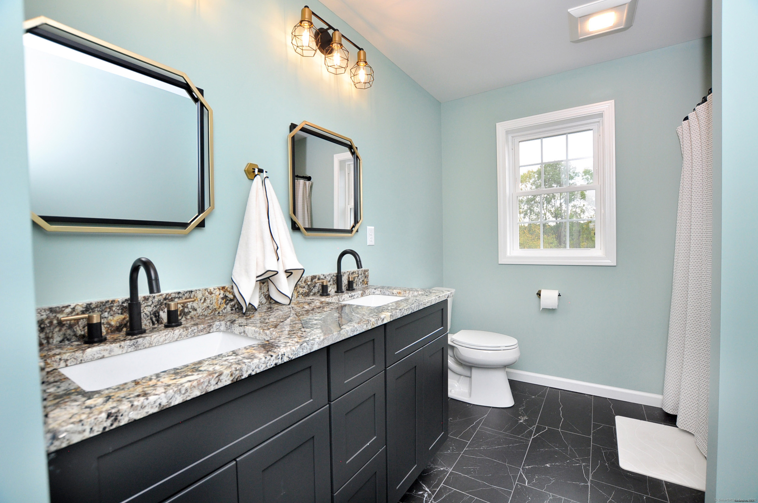 34 West River Road East Windsor, CT 06088 - Photo 22 of 31 a bathroom with a granite countertop toilet sink and mirror