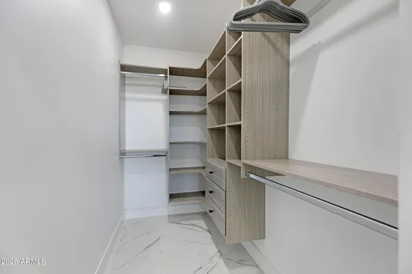 a bathroom with a double vanity sink mirror and tub