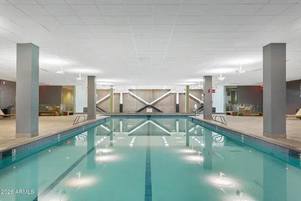 a view of a swimming pool with chairs in patio