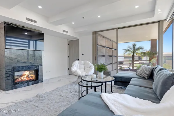 a living room with furniture and a fireplace