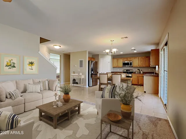 a living room with furniture kitchen view and a dining table
