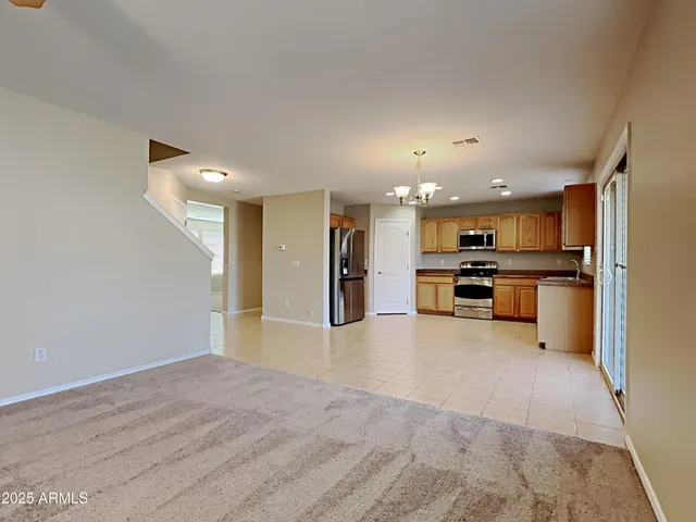 a view of kitchen with refrigerator and wooden floor