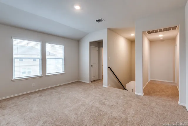 an empty room with a empty space and windows