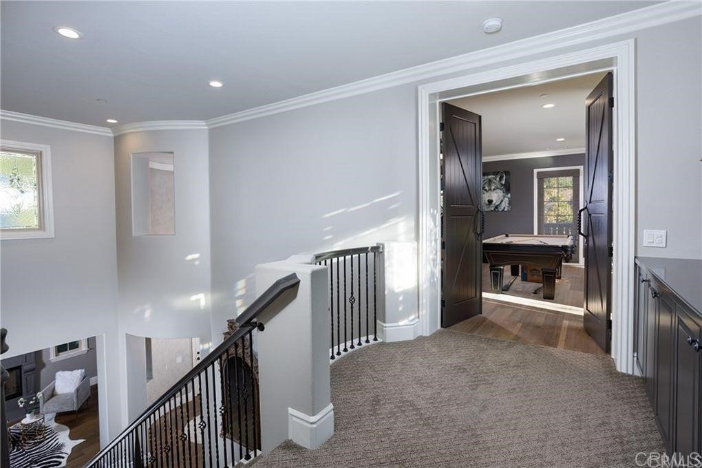 5 David Street Ladera Ranch, CA 92694 - Photo 12 of 22 a view of a hallway with wooden floor and stairs