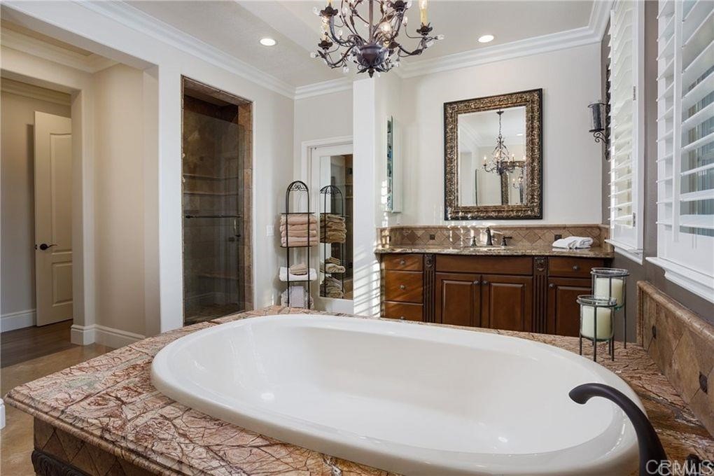 5 David Street Ladera Ranch, CA 92694 - Photo 10 of 22 a spacious bathroom with a granite countertop sink a mirror and a bathtub