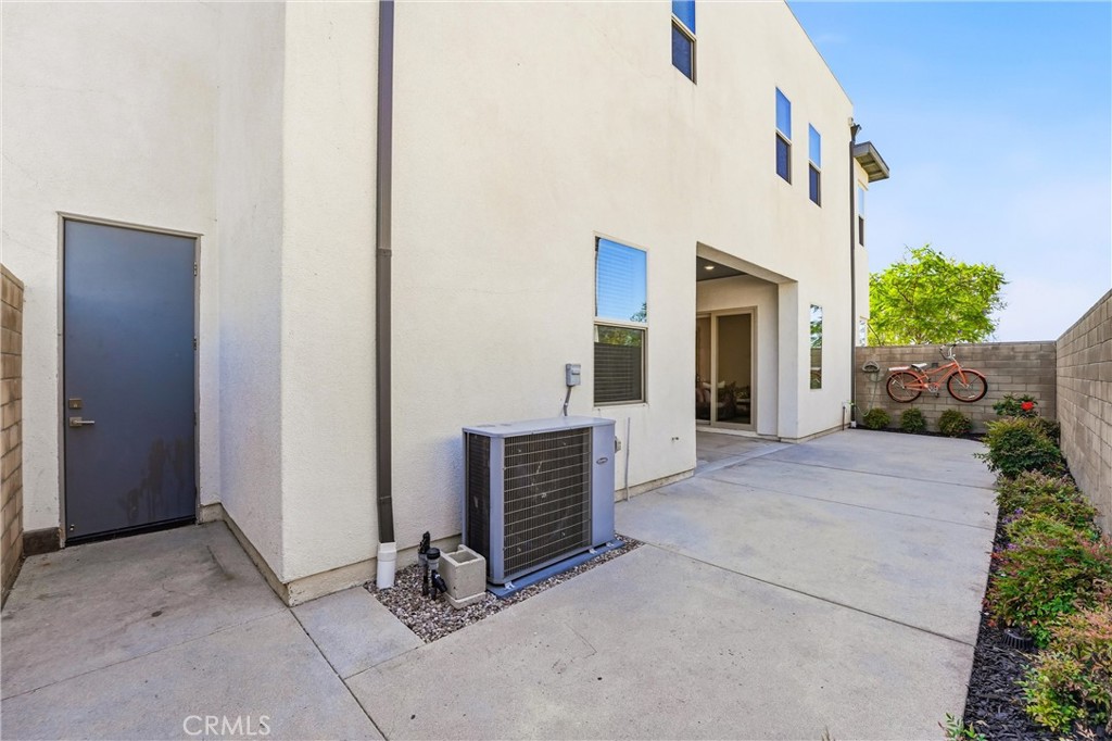 182 Scale Irvine, CA 92618 - Photo 26 of 61 The practical side of the picture: HVAC, utility door, and direct yard access. Everything you need, quietly tucked away.